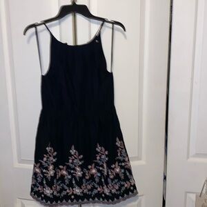 Francesca’s, Miami, Md, Black with floral embroidered design w/ scalloped edge.